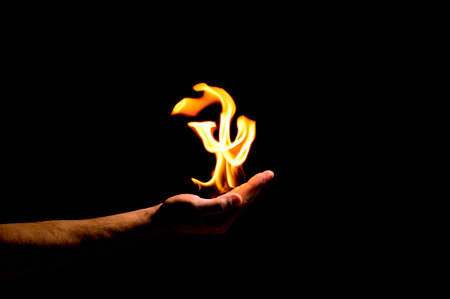 fire in hand on a black backgroundの写真素材