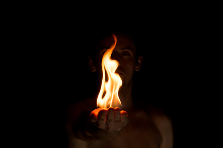 fire in hand on a black backgroundの写真素材