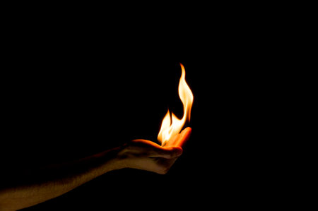 fire in hand on a black backgroundの写真素材