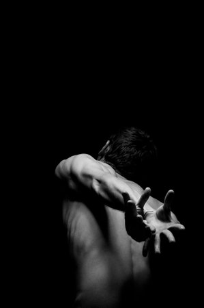 dramatic portrait of a guy in a distorted poseの写真素材