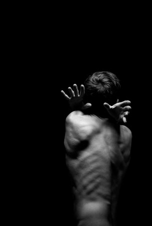 dramatic portrait of a guy in a distorted poseの写真素材