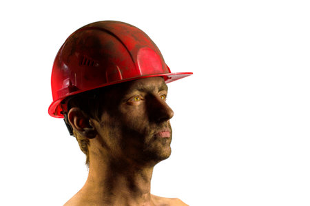 portrait of a guy, face and hard hat in coal dust