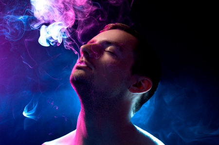 guy on a blue background with smoke
