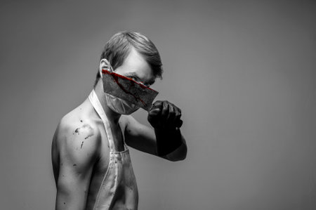 black and white dramatic portrait of a guy with a bloody knife