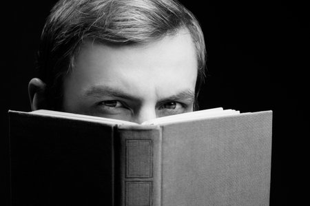 black and white portrait of a guy reading a bookの写真素材