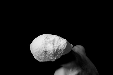 black and white photo of a man in a plaster maskの写真素材
