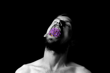 black and white portrait of a guy from the mouth flowersの写真素材