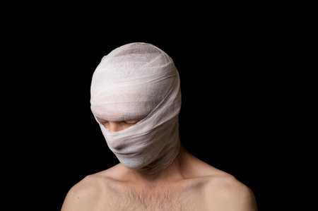 portrait of a guy head wrapped in a bandageの写真素材