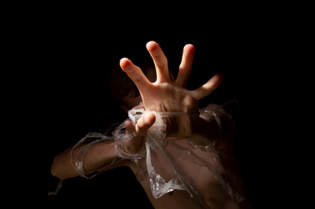 black and white photo, hands entangled in polyethyleneの写真素材