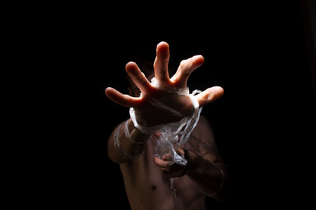 black and white photo, hands entangled in polyethyleneの写真素材