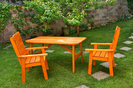a deska nd two chairs in the gardenの写真素材