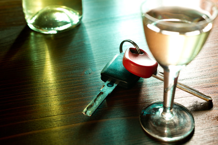 car key nand glass of liquer on the tableの写真素材