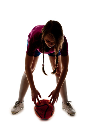 silhouette of girl playing footballの写真素材
