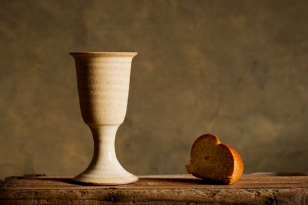 chalice of wine and bread on the dark backgroundの写真素材