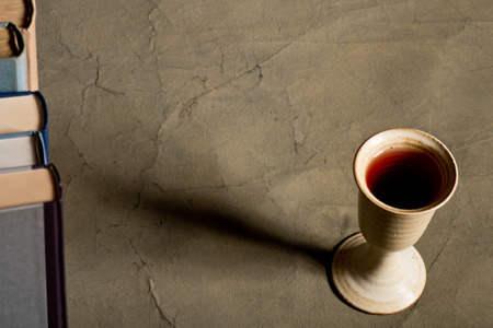 chalice of wine with books on the table