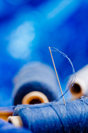 needle with blue thread on the blue backgroundの写真素材