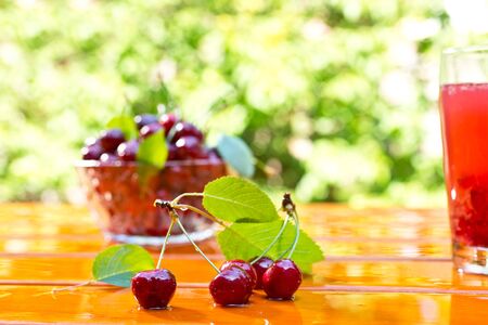 red cherry with bowl and juice on the table,shallow depth of fieldの写真素材