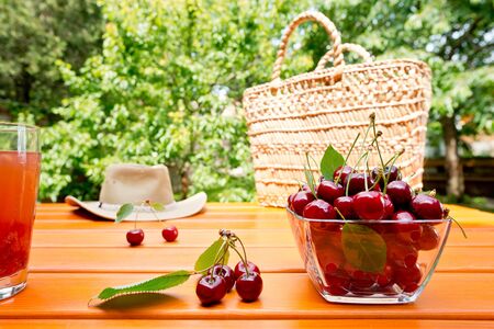 red cherry and shopping bag in the garden,shallow depth of fieldの写真素材