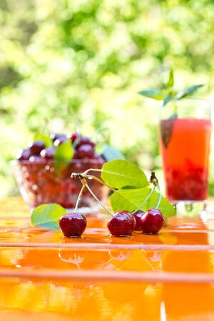 red cherry with bowl and juice on the table,shallow depth of fieldの写真素材