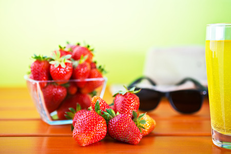 red ripe strawberry on the table in the gardenshallow depth of fieldの写真素材