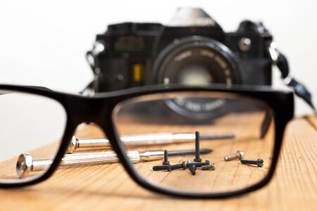 Analoque old camera with screws and screwdriwerの写真素材