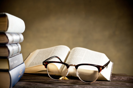Still life with eyeglasses and books on the tableの写真素材