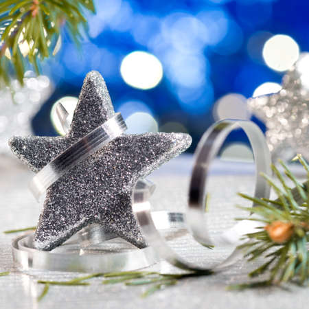 Silver Christmas star with needles and christmas decorationの写真素材