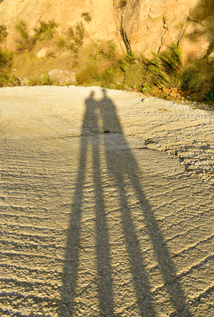 Shadows of a couple at the sunsetの写真素材
