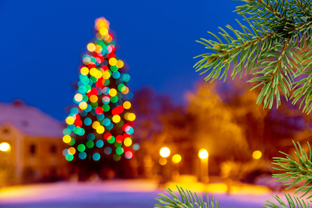 Christmas background with unfocused Christmas tree and snow by nightの写真素材