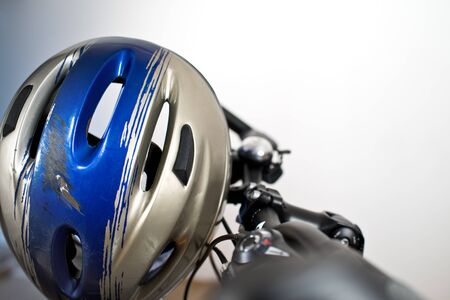 Old Scraped Safety Helmet On The Bikeの写真素材