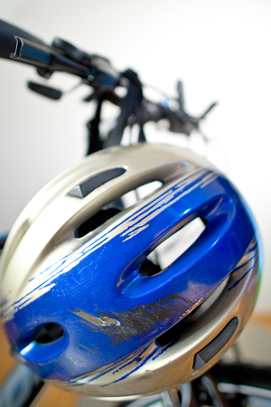 Old Scraped Safety Helmet On The Bikeの写真素材