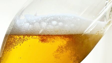 Pouring Beer into the Glass of Beer. Bottom View.の写真素材