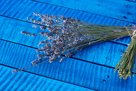 Bunch of lavender on the blue wooden desk.の写真素材