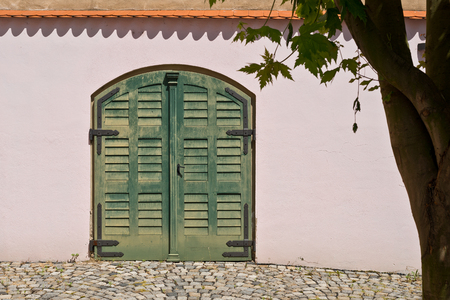 Wooden door in hop store house in Zatec town. Czech Republic.の写真素材
