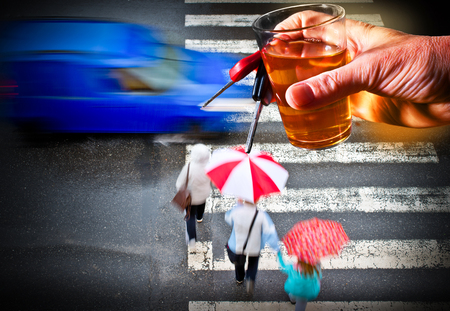 Hand holds glass of alcohol with car kayの写真素材