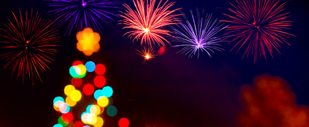 Unfocused Christmas Tree with a Fireworks by Nightの写真素材