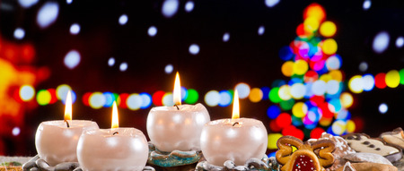 Advent Wreath with Burning Candles in  front of Christmas Treeの写真素材