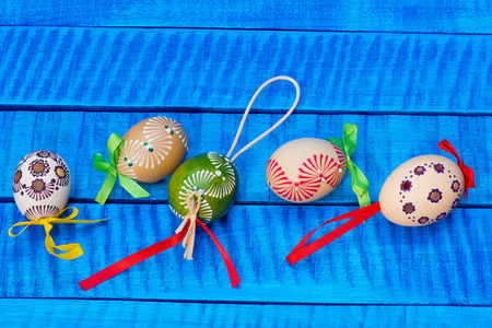 Painted Easter eggs on the blue tableの写真素材
