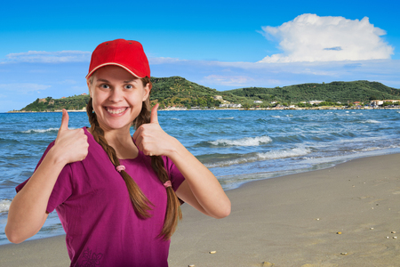 A smiling girl on the sandy beach.の写真素材