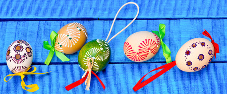 Painted Easter eggs on the blue tableの写真素材