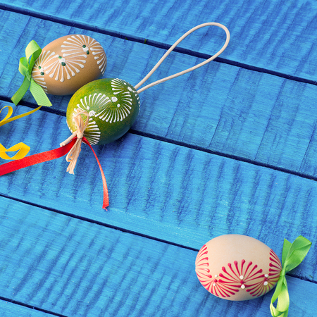 Painted Easter eggs on the blue tableの写真素材