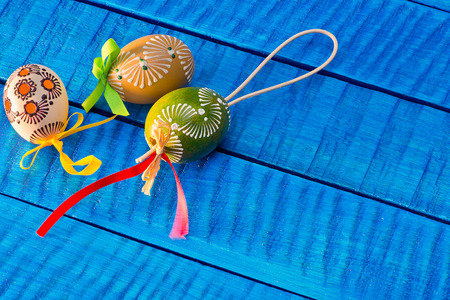 Painted Easter eggs on the blue tableの写真素材
