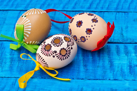 Painted Easter eggs on the blue tableの写真素材
