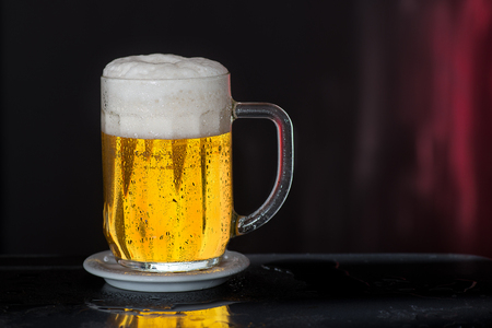 Glass of beer with drops of waterの写真素材