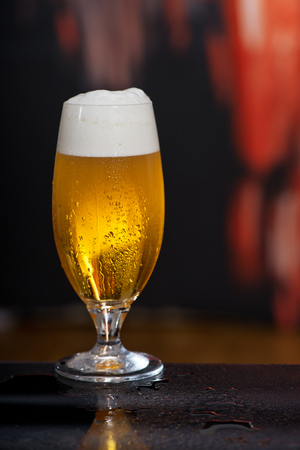 Glass of beer on the dark backgroundの写真素材
