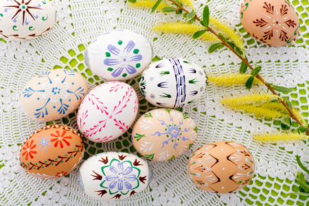 Painted Easter eggs with a blossom on the deskの写真素材