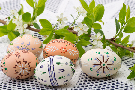 Painted Easter eggs with a twig on the deskの写真素材