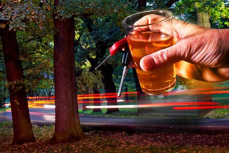 Man Holding Car Key and Glass of Spiritsの写真素材