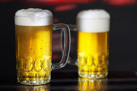 Glasses of beer on the dark backgroundの写真素材