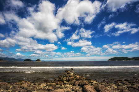 Musulmok beach scene filled with pebbles and rock  Taken under a beautiful clouds  の写真素材